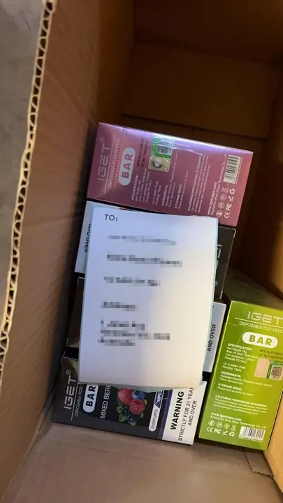 Genuine IGET Flare B10000 order packed for dispatch — shipping label blurred for privacy